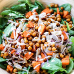 Spinach salad with roasted chickpea, sweet potato and onions